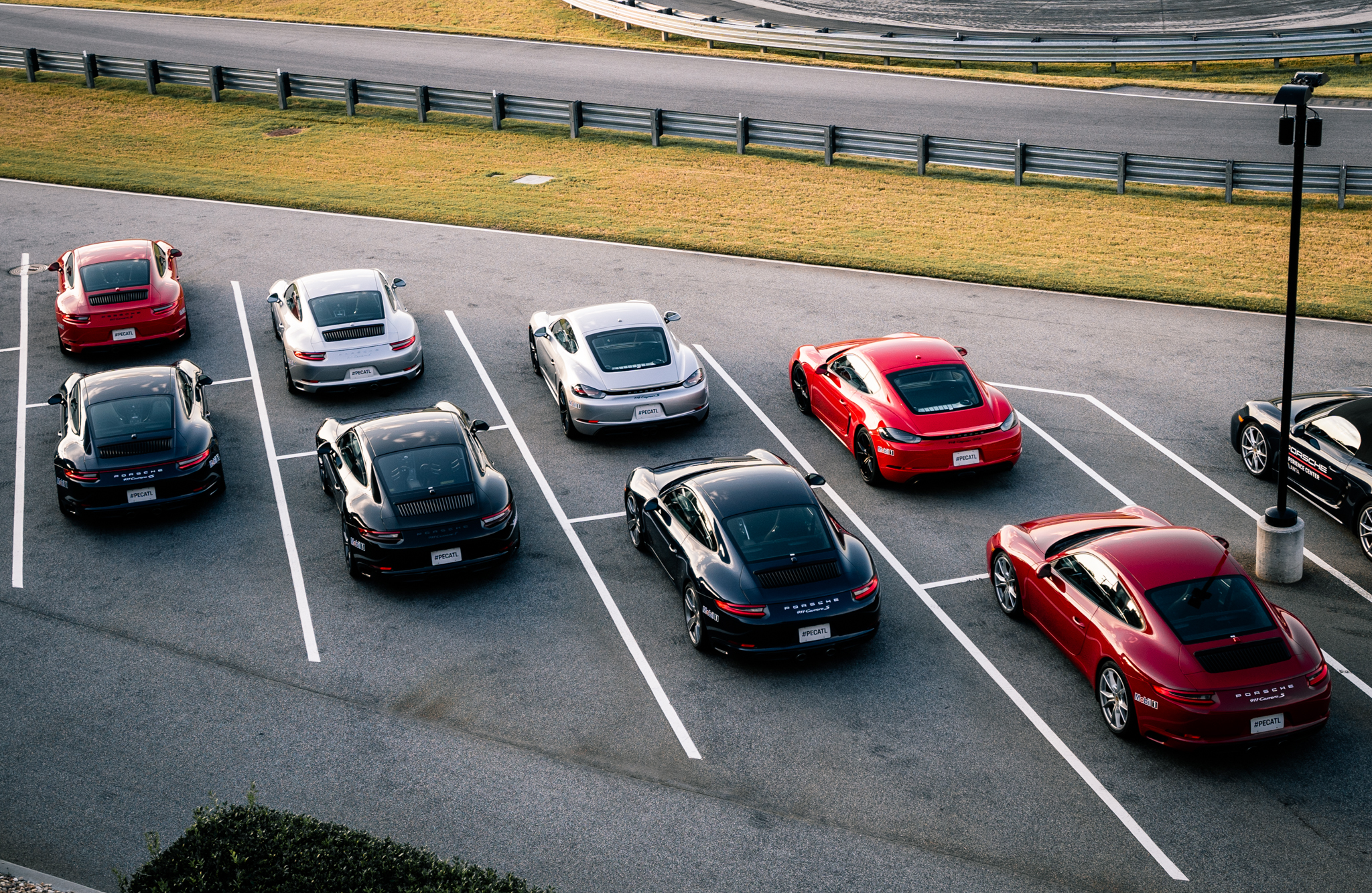 Lineup of Porsche vehicles in the parking area