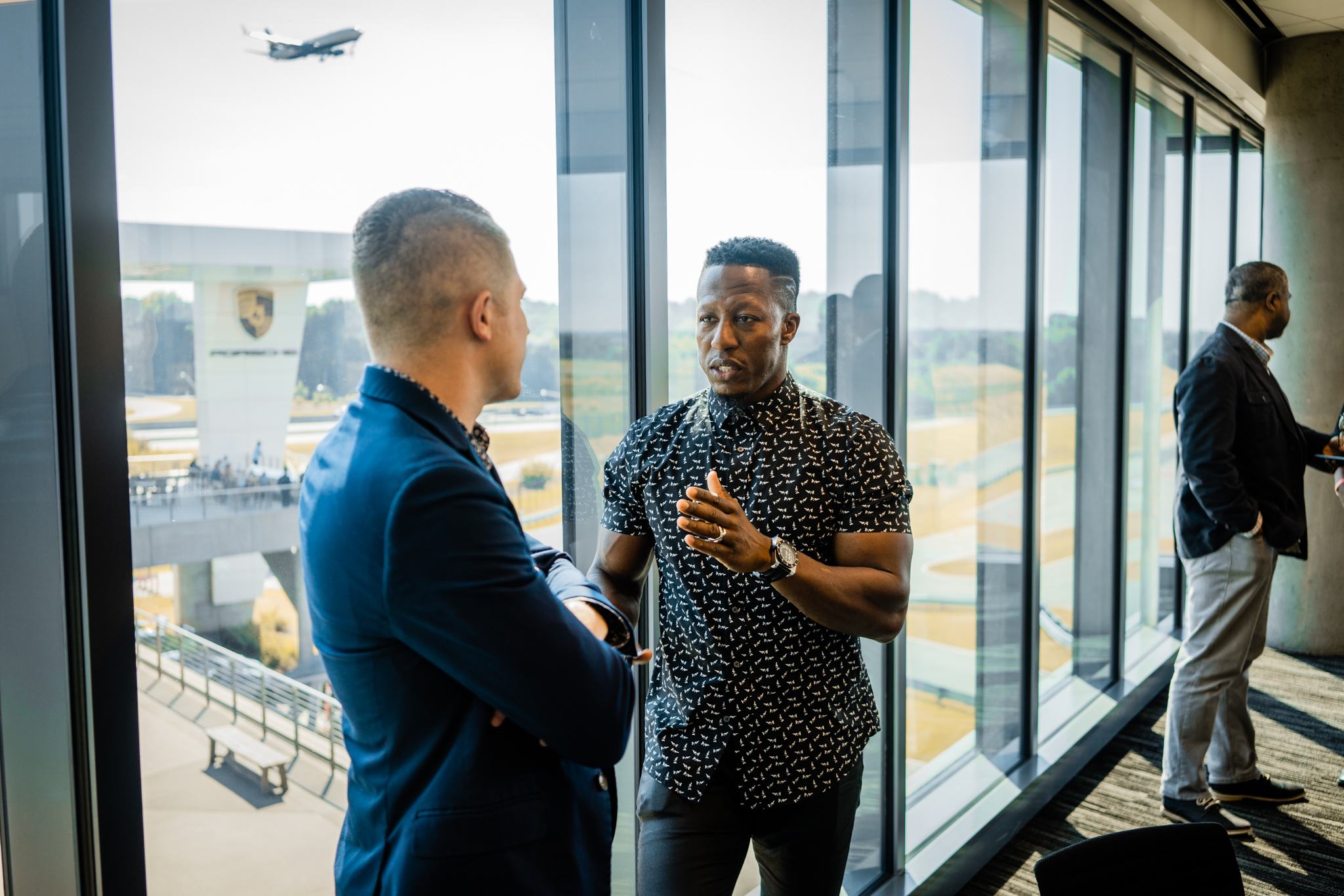 Leaders networking with track views in the background