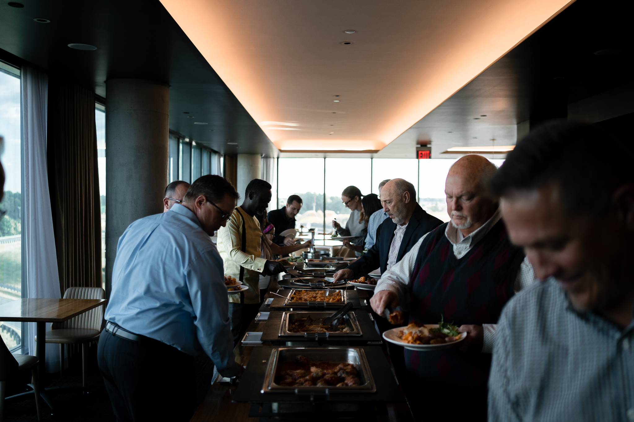 Attendees gathering around the lunch buffet